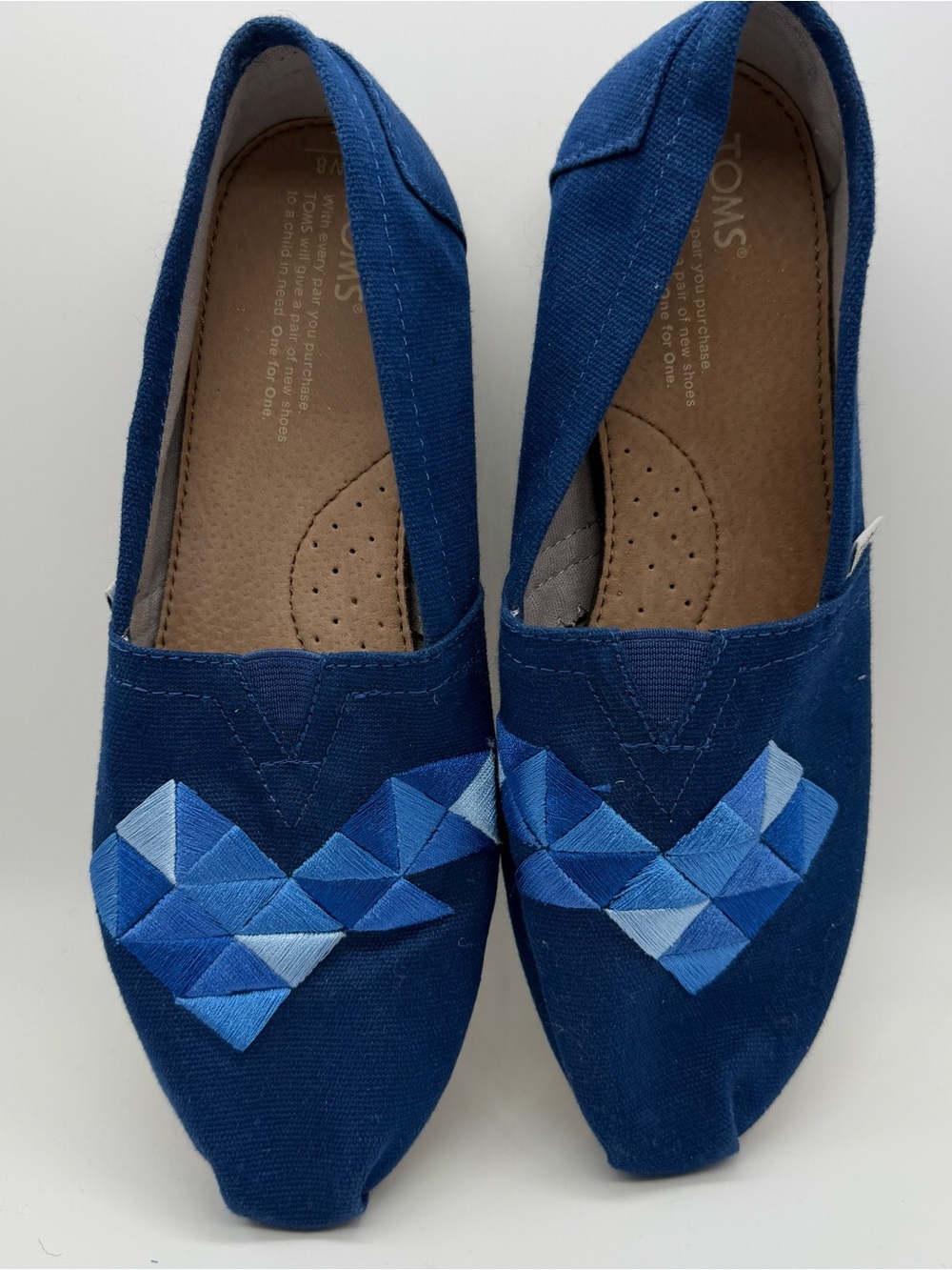 TOMS Women’s Navy Blue Canvas Slip-On Shoes with Blue Embroidered Design, size 8